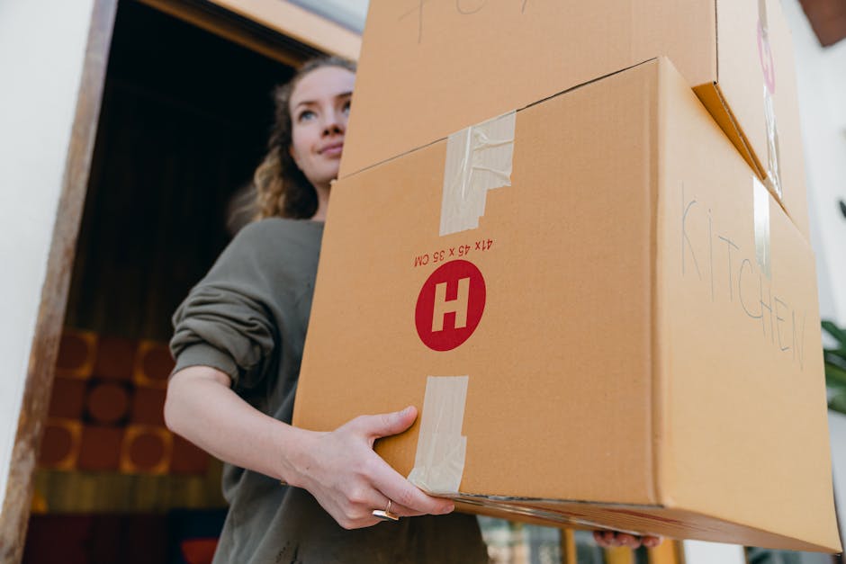 Movers carrying stacked boxes carefully